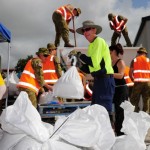 volunteers and Army Reserve soldiers from Queensland fill sandbags. Australian Department of Defence / Corporal (CPL) Janine Fabre